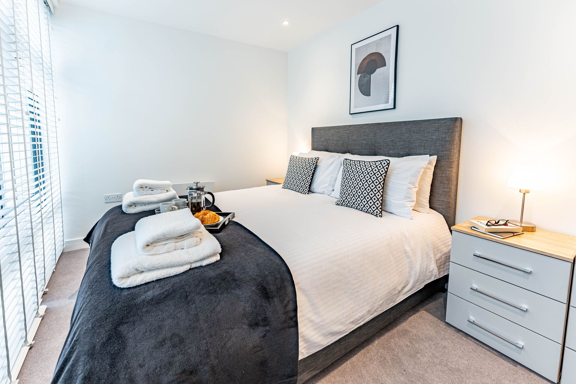 wellington house bedroom with folded towels and food tray from the housekeeping team