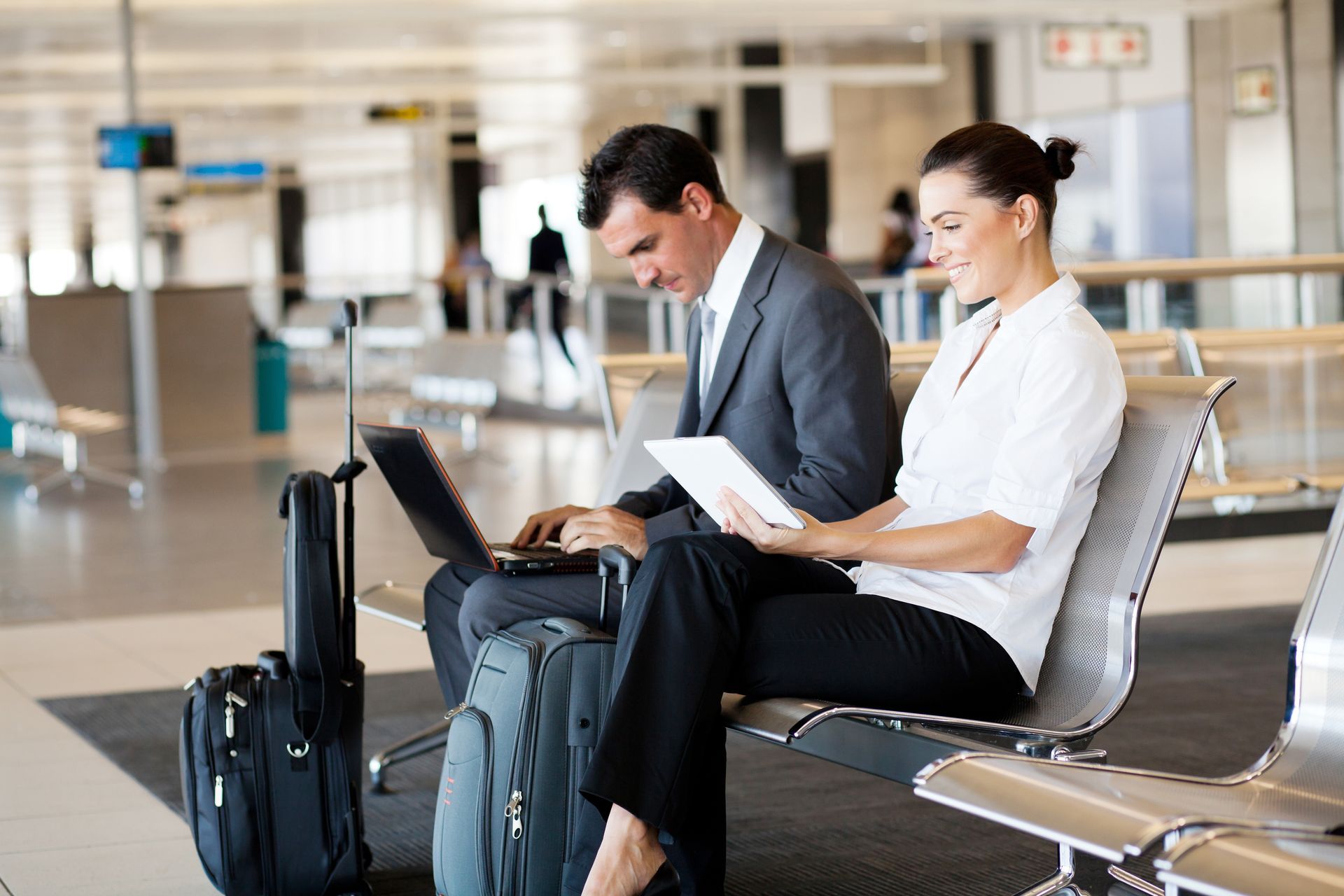 Group of business professionals waiting with luggage in an airport terminal