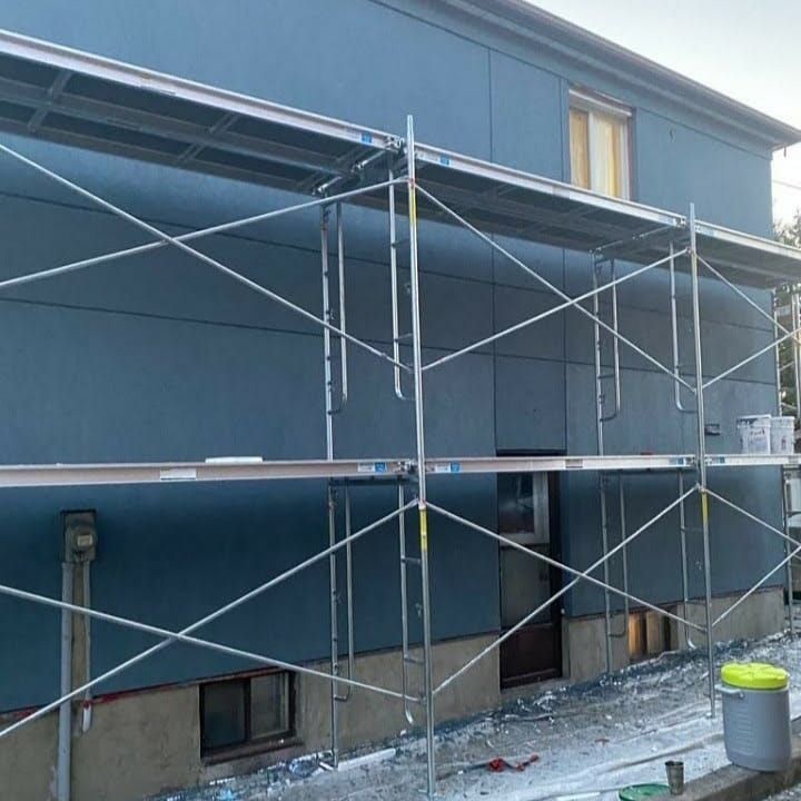 a blue building with scaffolding on the side of it