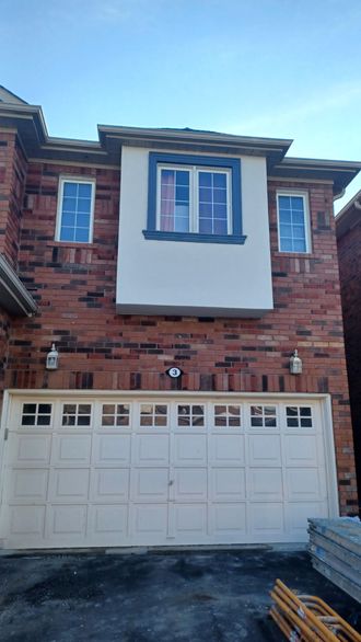 a large brick house with a white garage door
