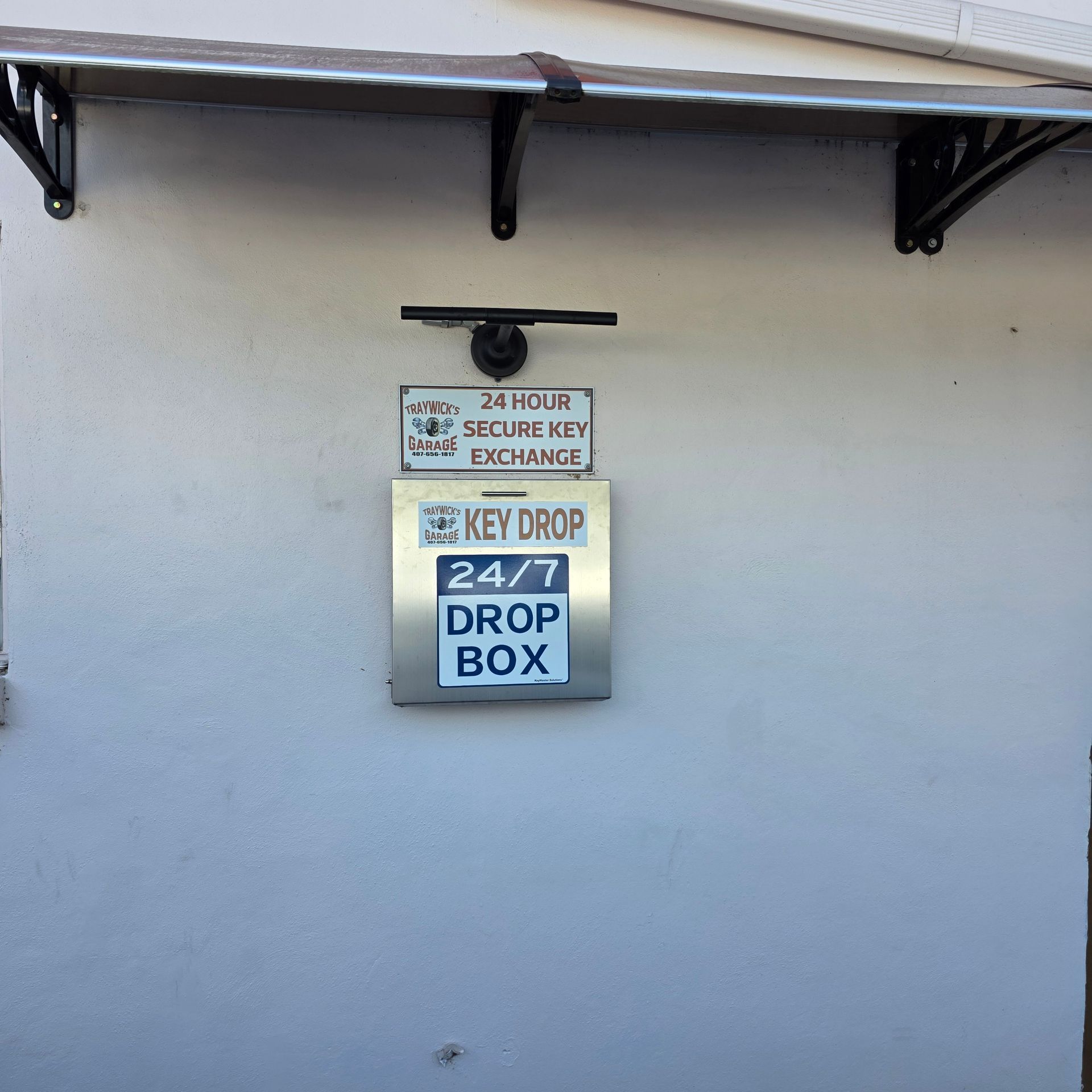 Wall-mounted key drop box, labeled 