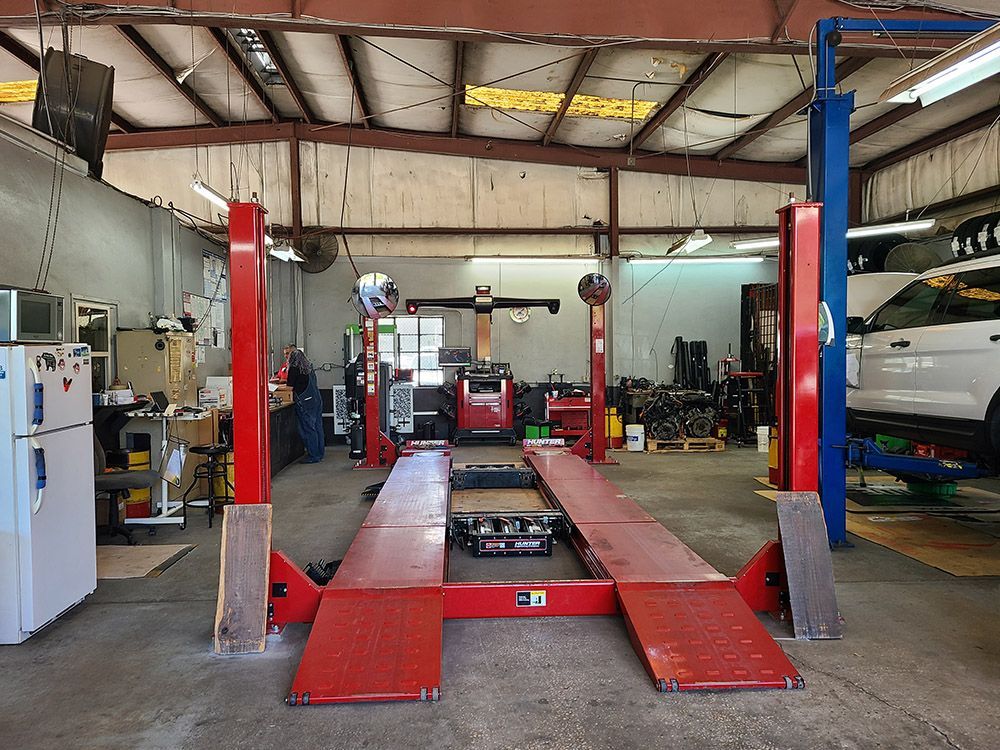 Red car lift in a car repair shop.