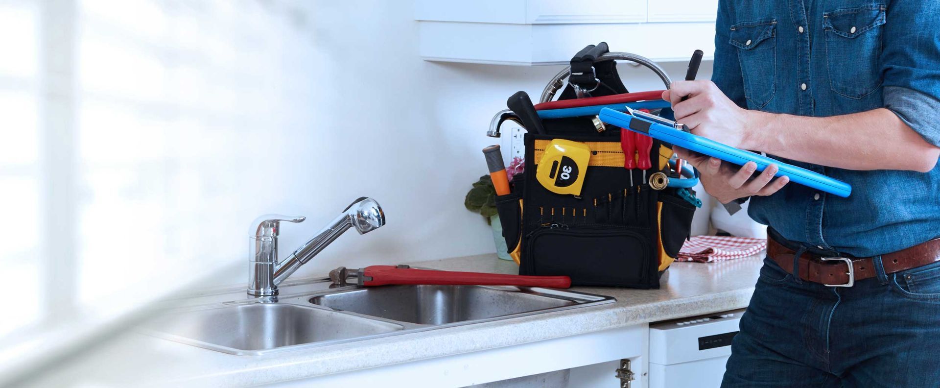 Hand smoothing a gray cement surface with a metal trowel.