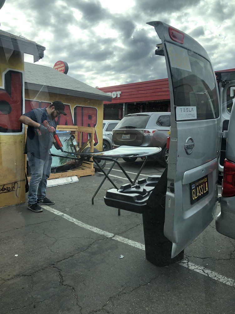 A man is repairing a windshield.