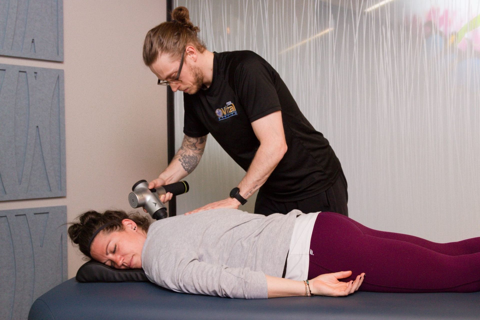 A man is giving a woman a massage on a table.