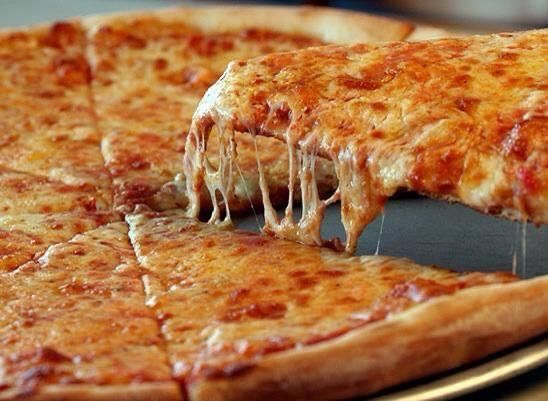A close up of a pizza with a slice taken out of it.