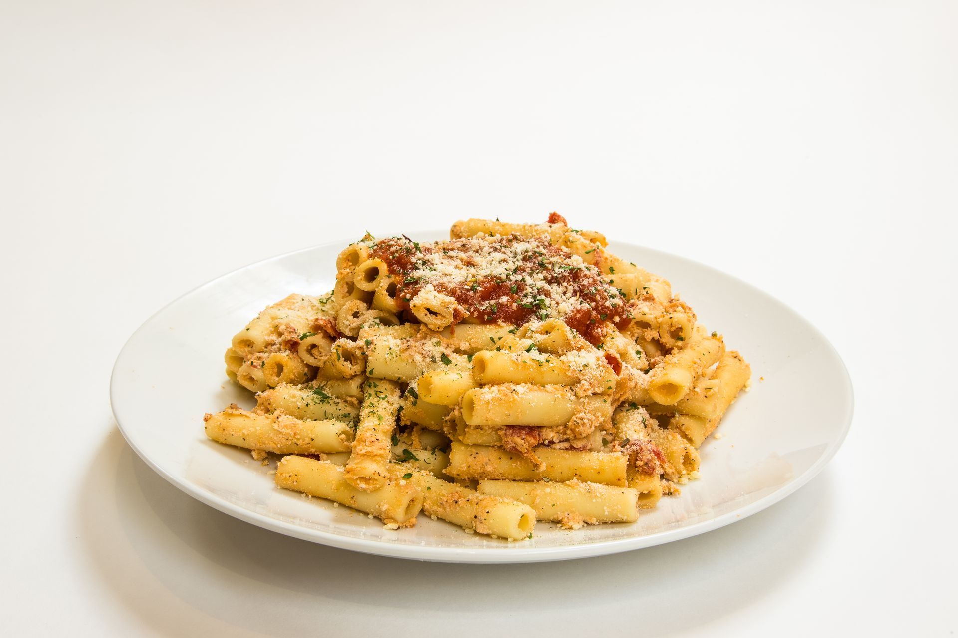 A white plate topped with macaroni and cheese on a white surface.