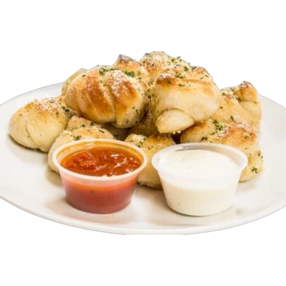 A white plate topped with garlic knots and dipping sauce