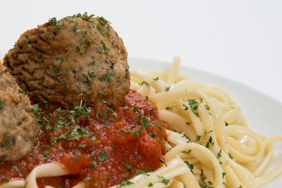 A plate of spaghetti and meatballs with tomato sauce