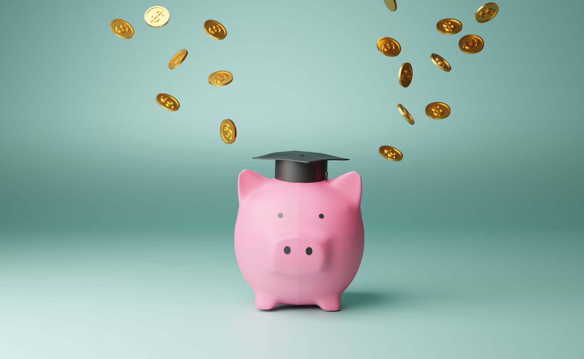 A pink piggy bank with a graduation cap on it.