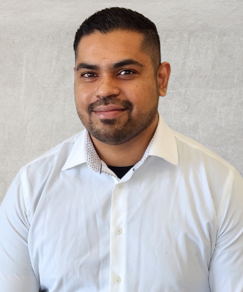 A man with a beard is wearing a white shirt