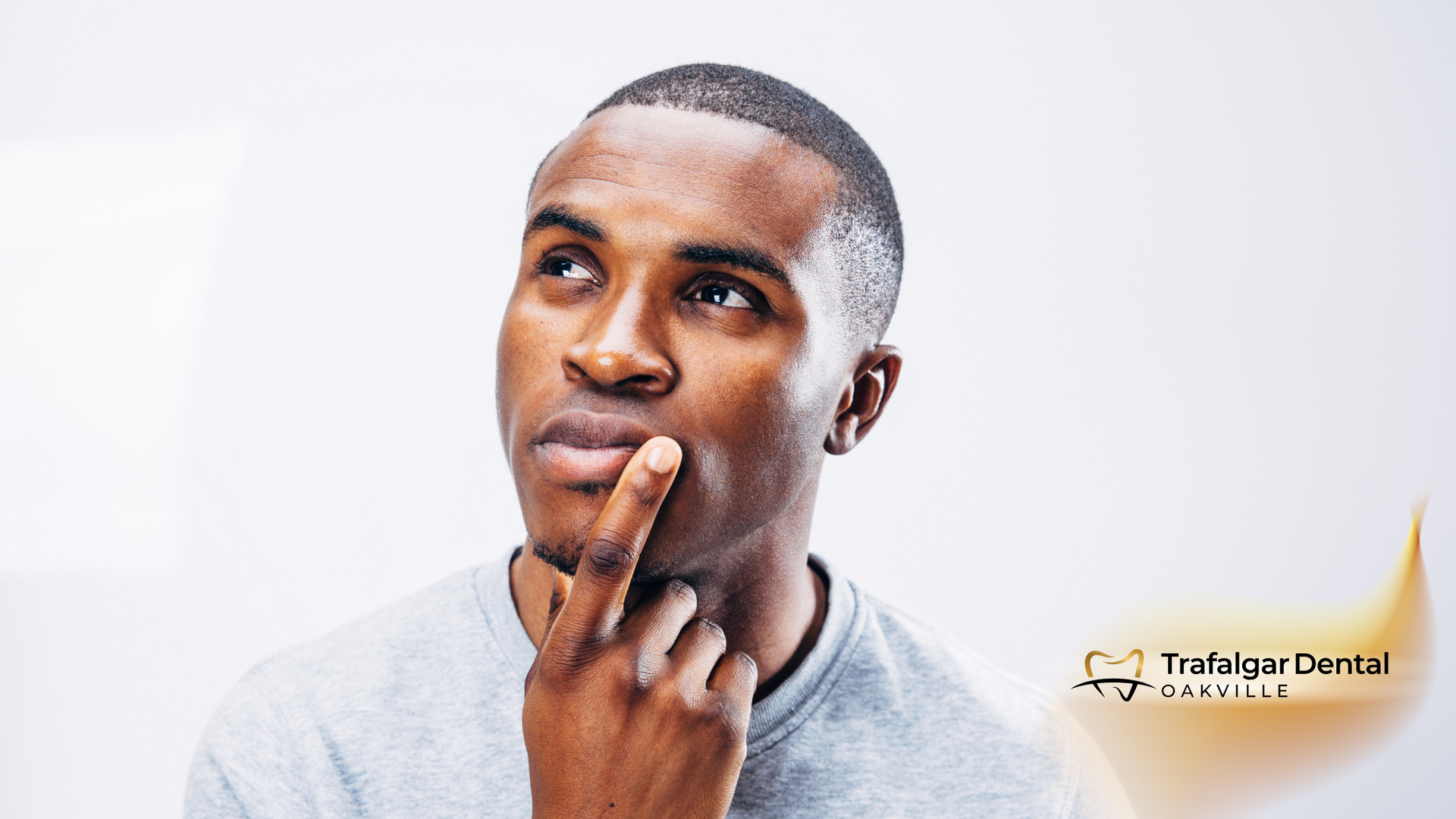 A man is thinking with his hand on his chin.