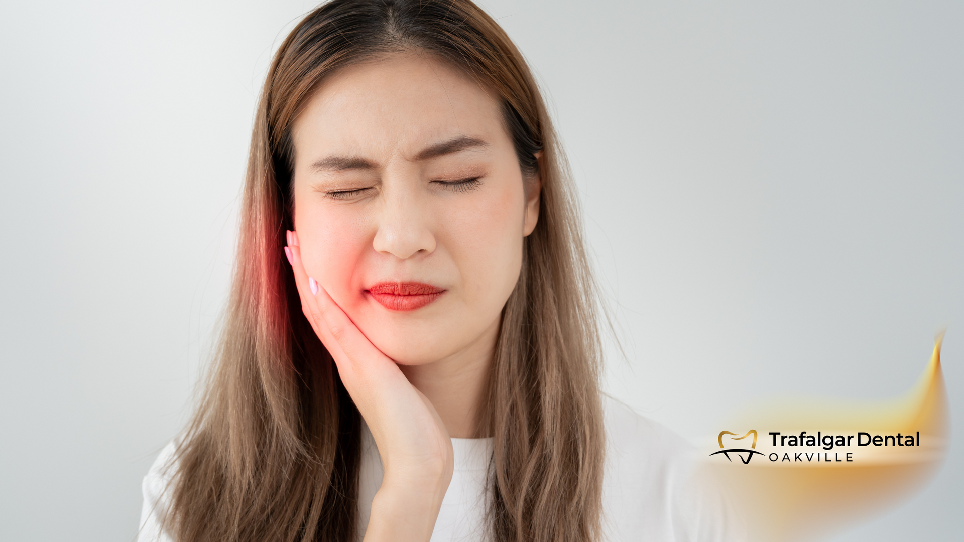 A woman is holding her face in pain because of a toothache.