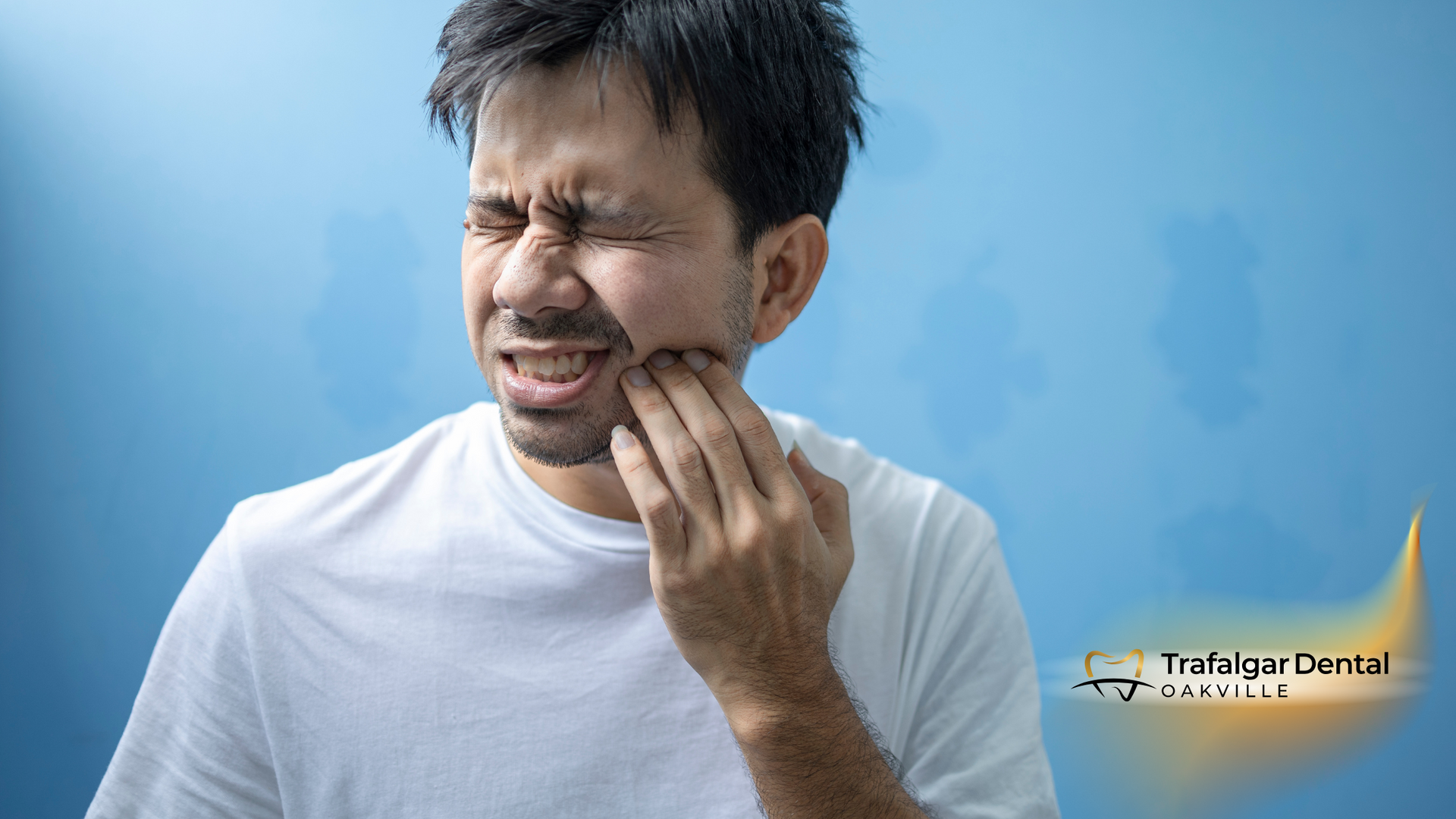A man is holding his mouth in pain because of a toothache.