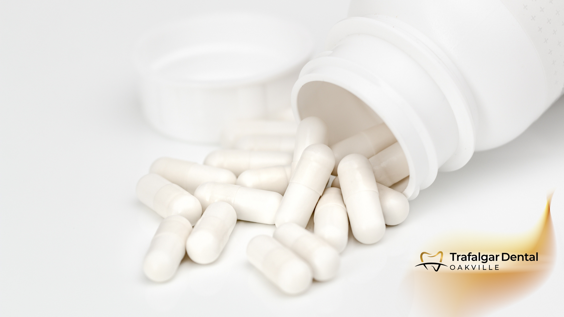 White pills pouring out of a white bottle
