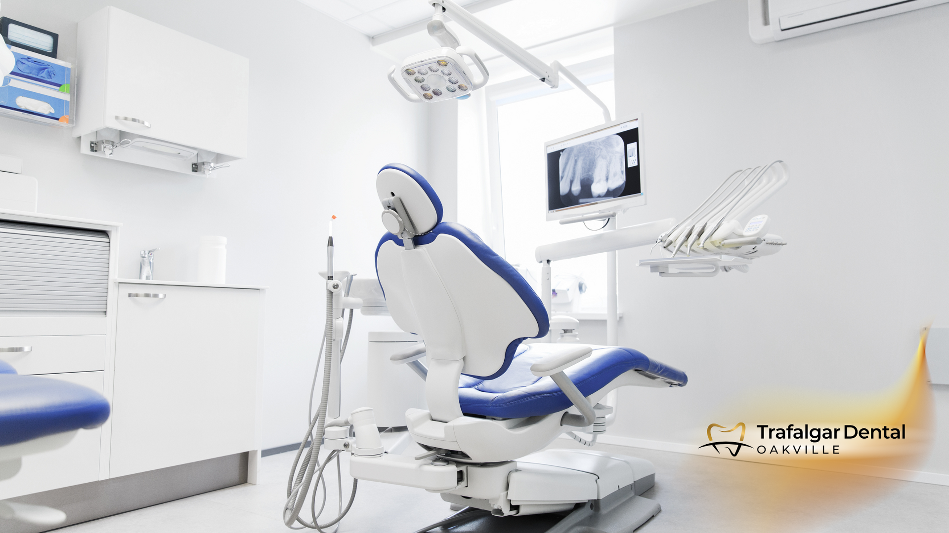 An empty dental office with a blue and white dental chair.