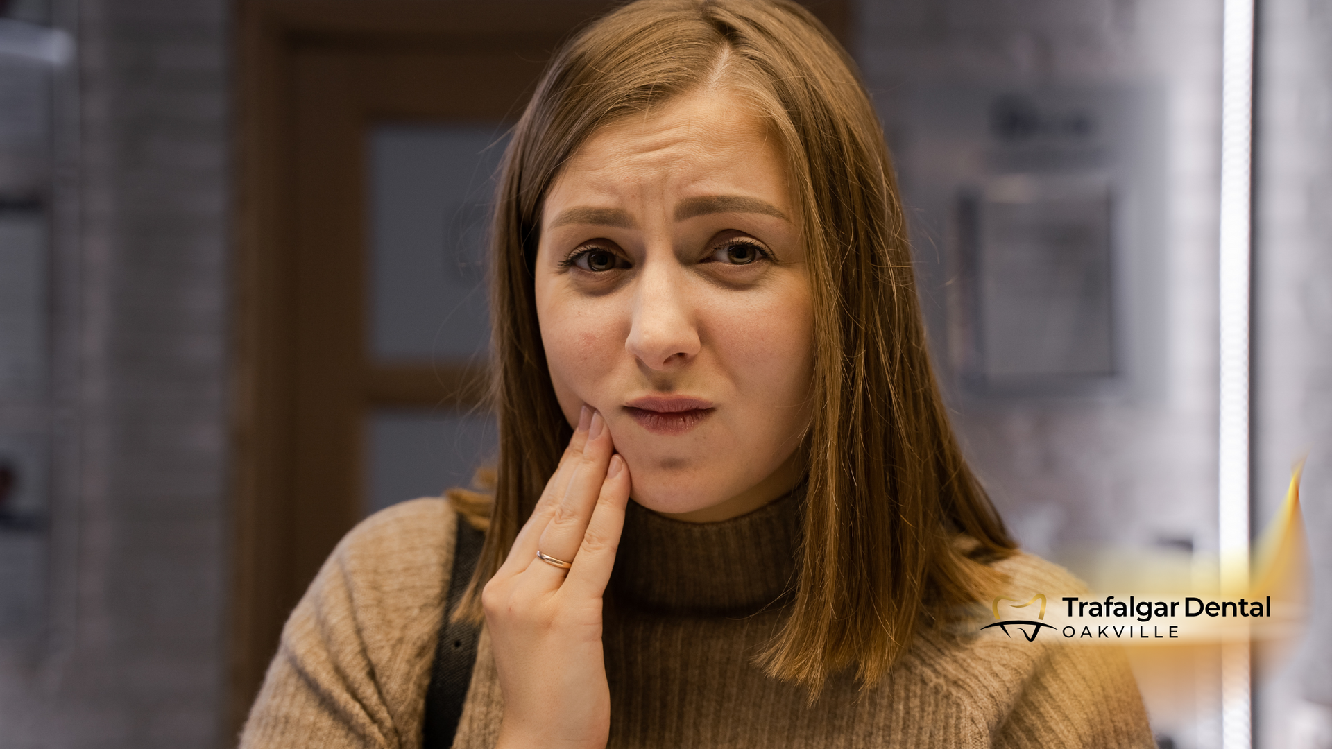 A woman is touching her face because she has a toothache.