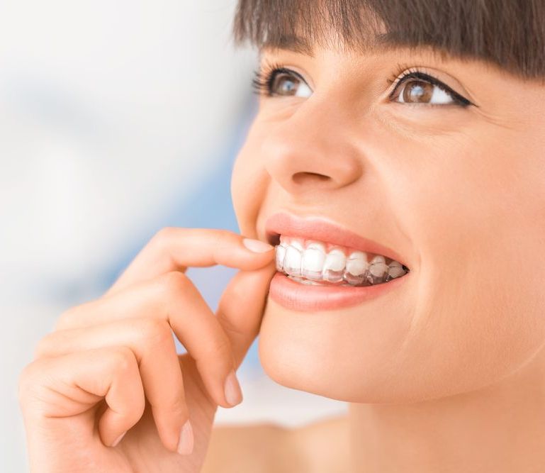 A woman is having her teeth examined by a dentist.