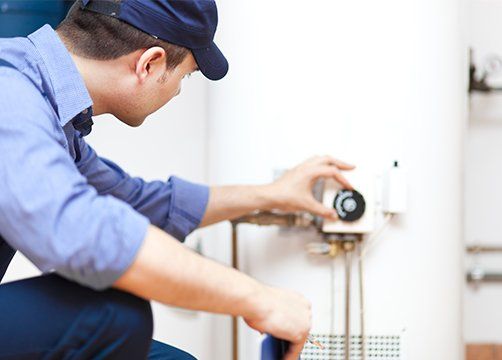 Technician Repairing Water Heater — Hammond, IN — Area Plumbing and Sewer Co., Inc.