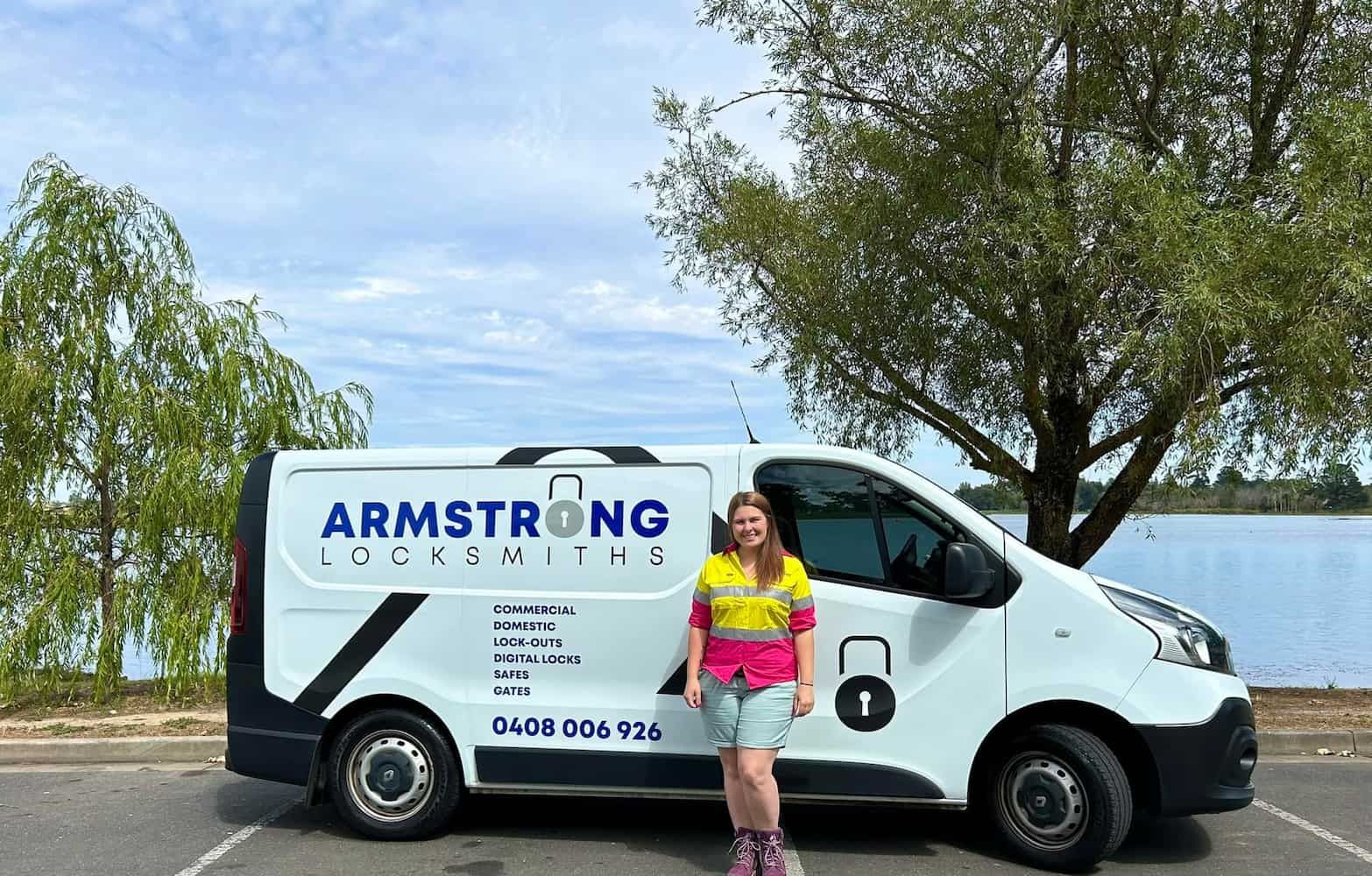 a Woman is Standing Next to a White Van in a Parking Lot — Armstrong Locksmiths Ballarat in Ballarat East, VIC