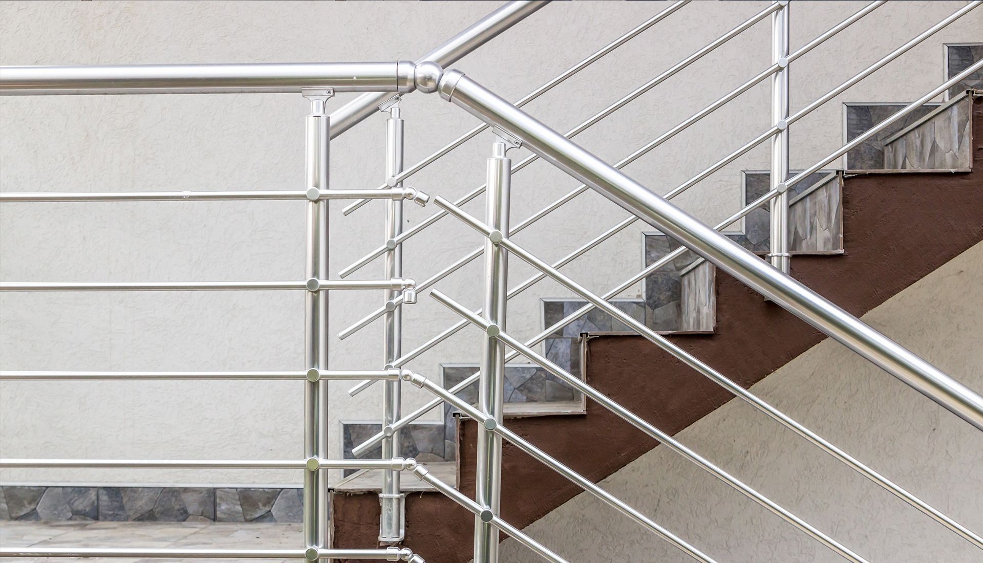 Metal staircase with horizontal and diagonal bars for the railing.