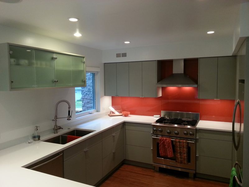 A kitchen with stainless steel appliances and gray cabinets
