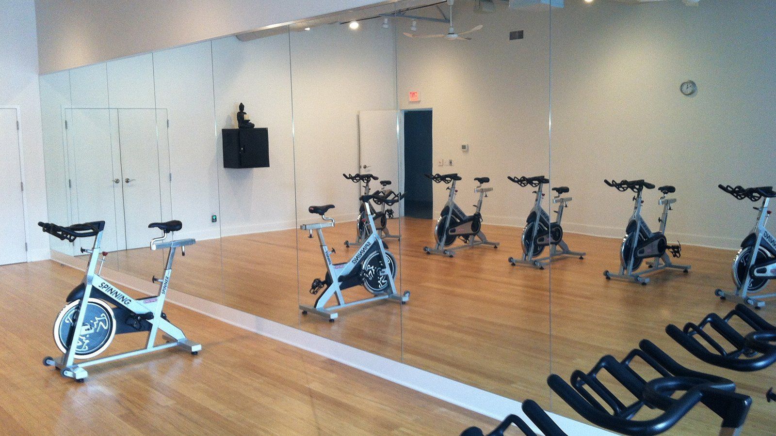 A gym with a lot of exercise bikes in it