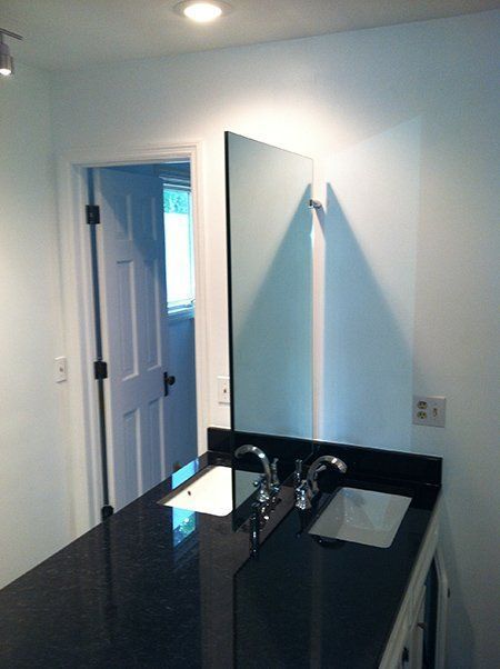 A bathroom with two sinks and a large mirror