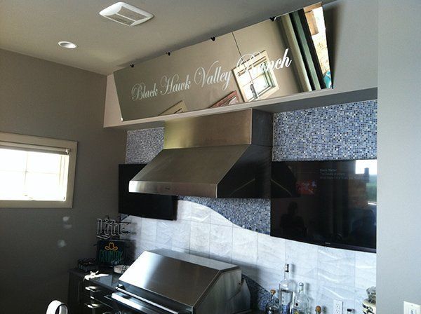 A kitchen with stainless steel appliances and a sign that says black park valley ranch