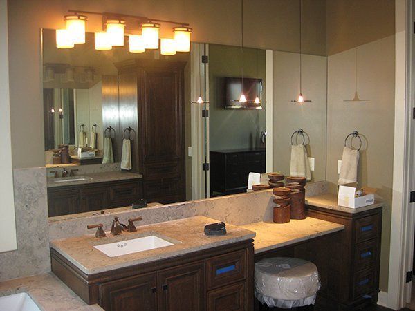 A bathroom with two sinks and a large mirror