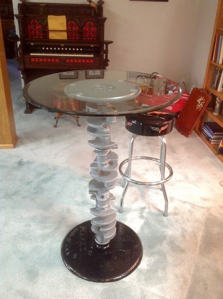 A glass table with a metal base in a living room