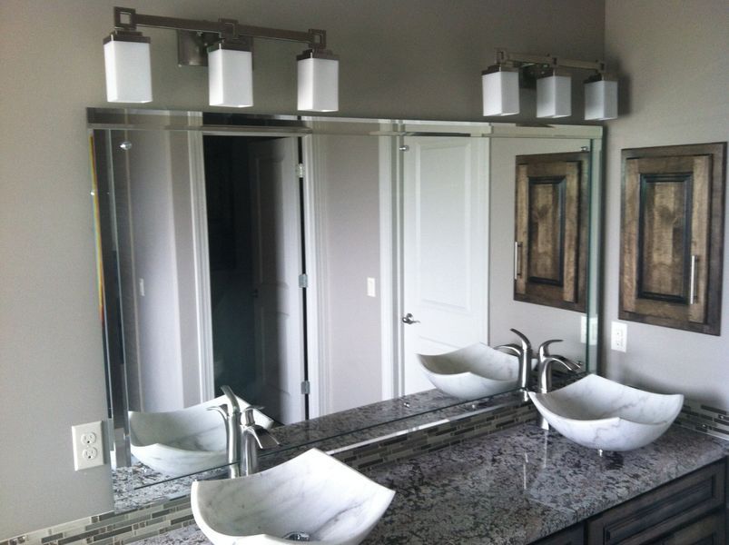 A bathroom with two sinks and a large mirror