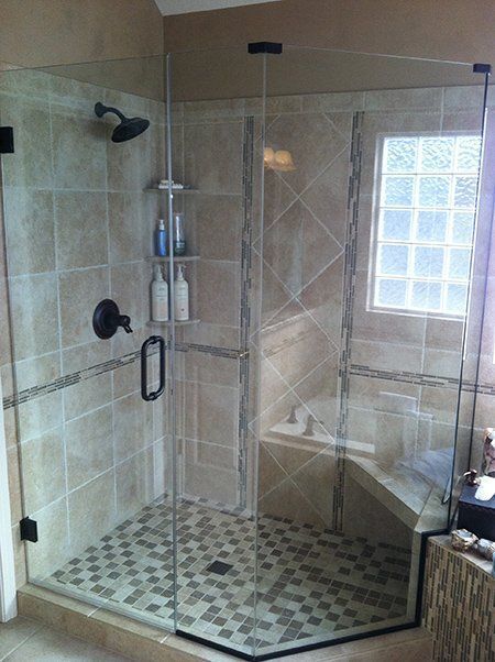 A bathroom with a walk in shower and a tub.