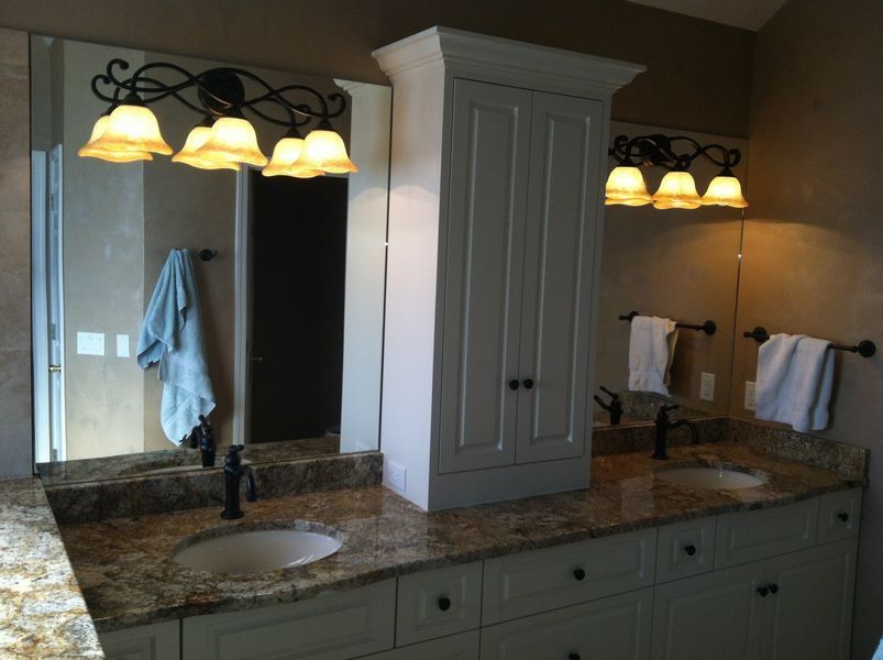 A bathroom with two sinks and two mirrors