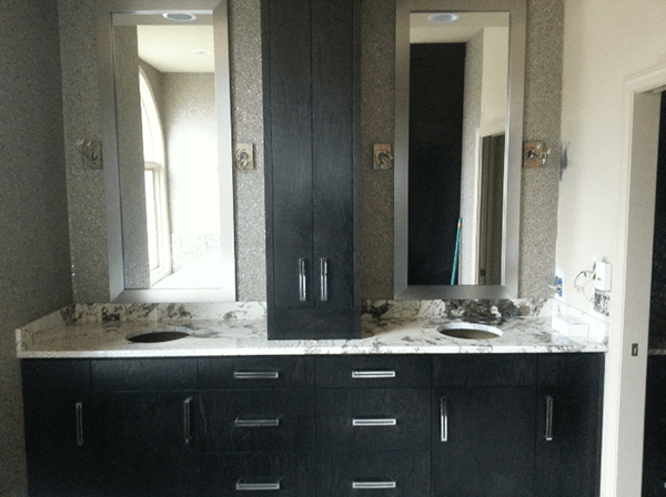 A bathroom with two sinks and two mirrors