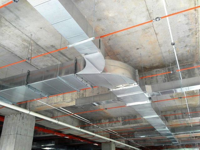 A ceiling with a lot of pipes hanging from it