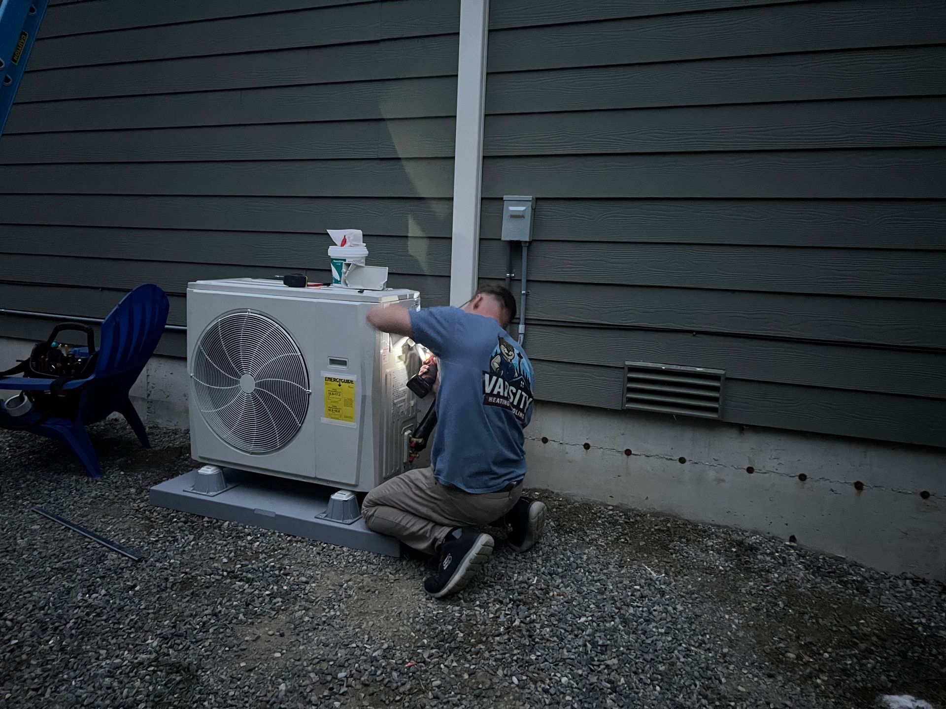Two air conditioners are sitting outside of a brick building.