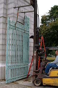 Old Light Green Gate carried by lifting machine— Railings in Plymouth, MA