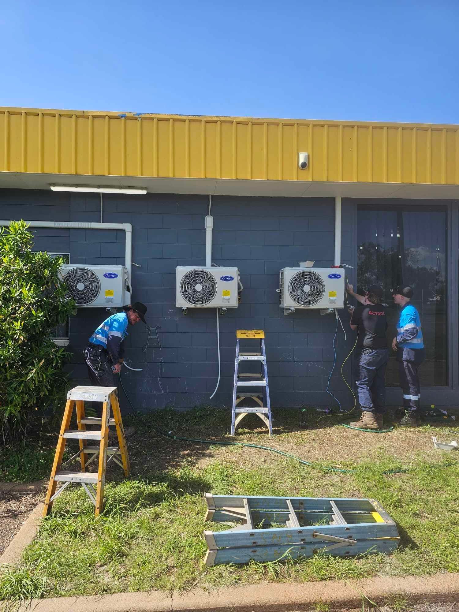 Man Fixing Aircon — Refrigeration Services in Mount Isa, QLD
