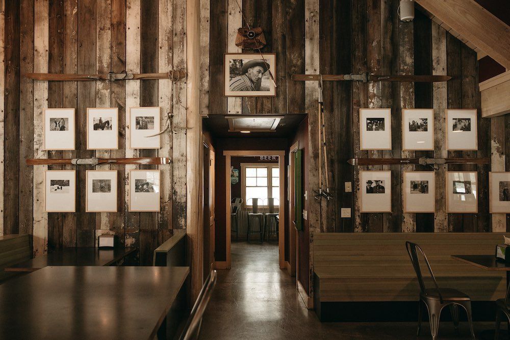A room with a wooden wall and pictures on the wall.