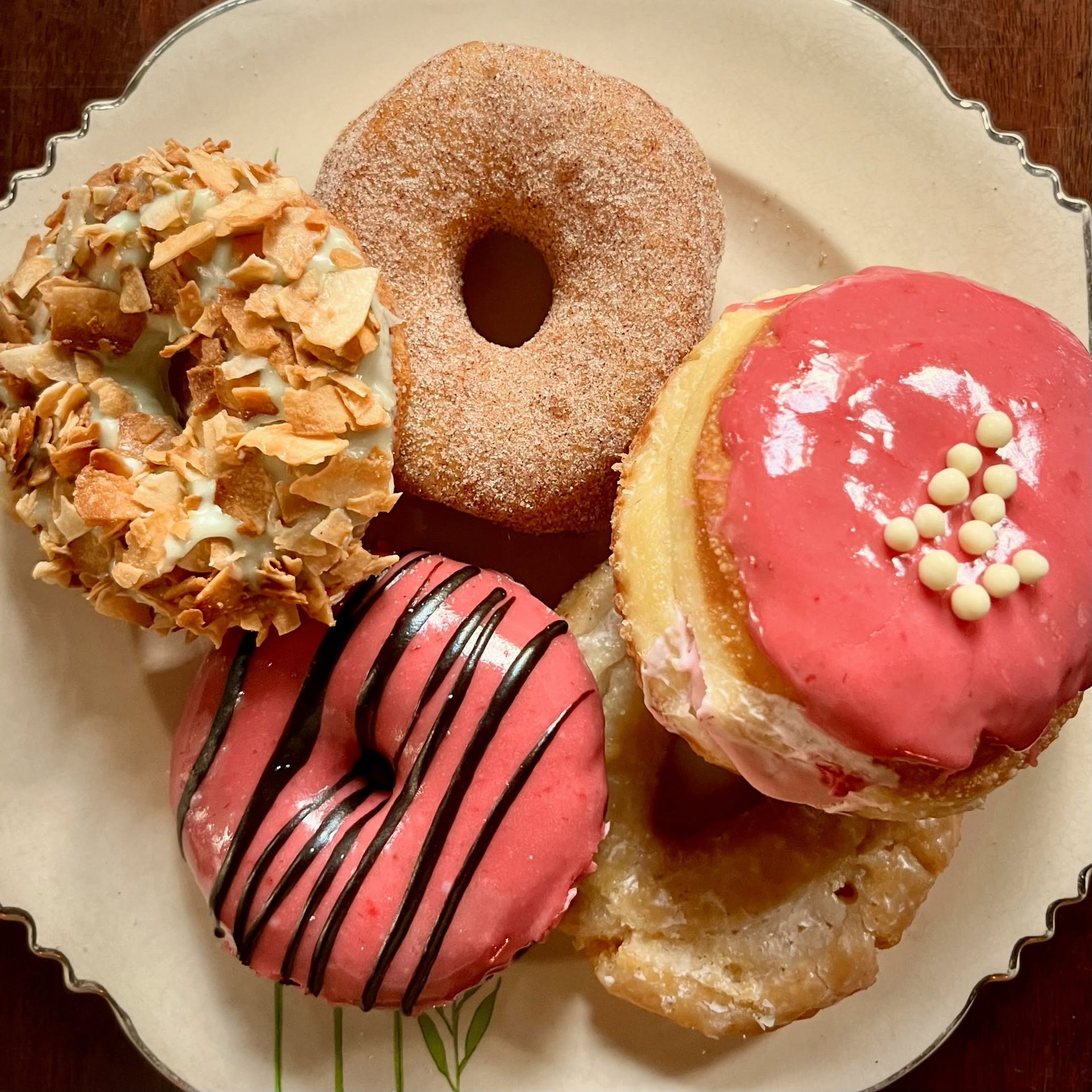 Four different types of donuts are on a plate