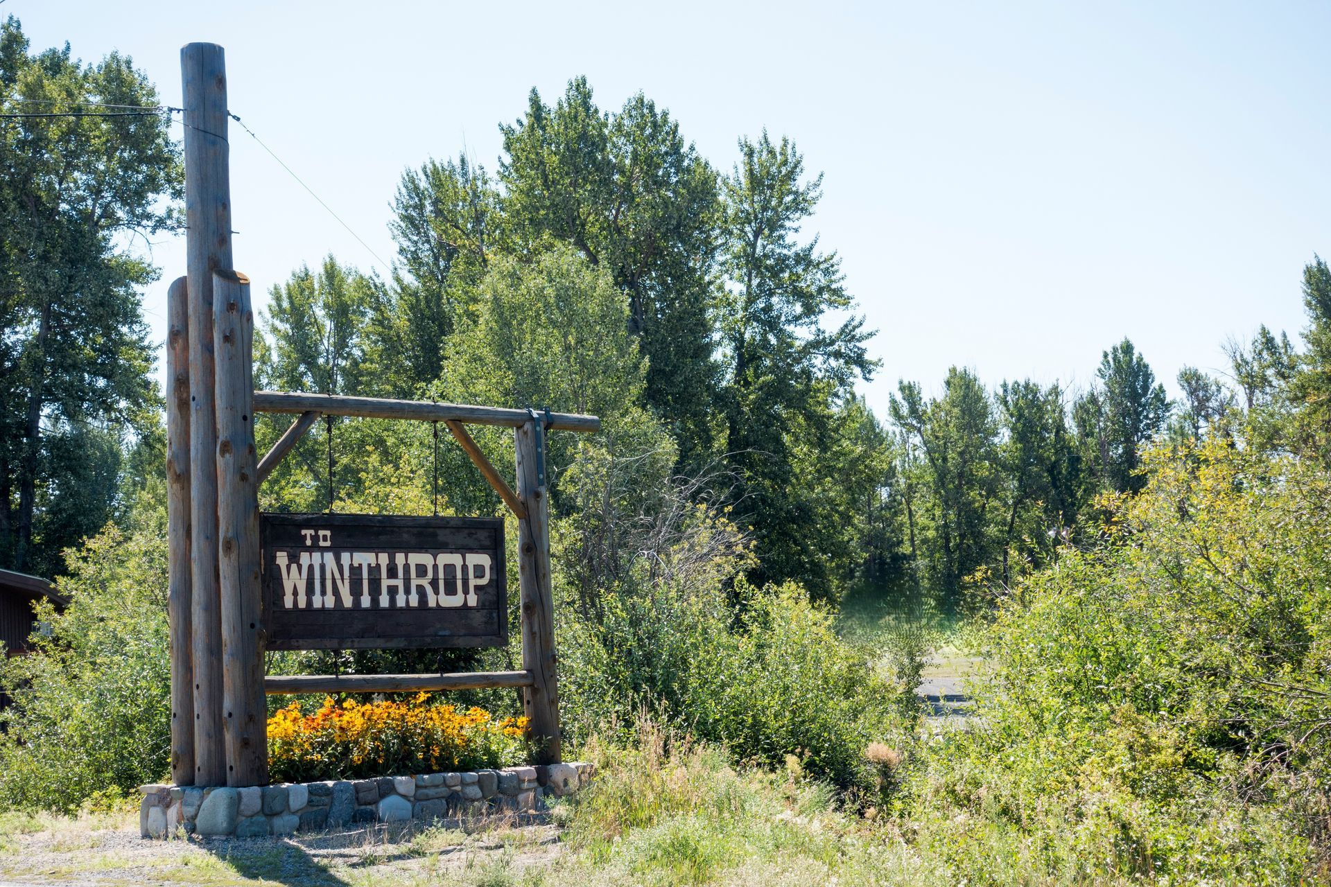 A wooden sign that says to winthrop on it