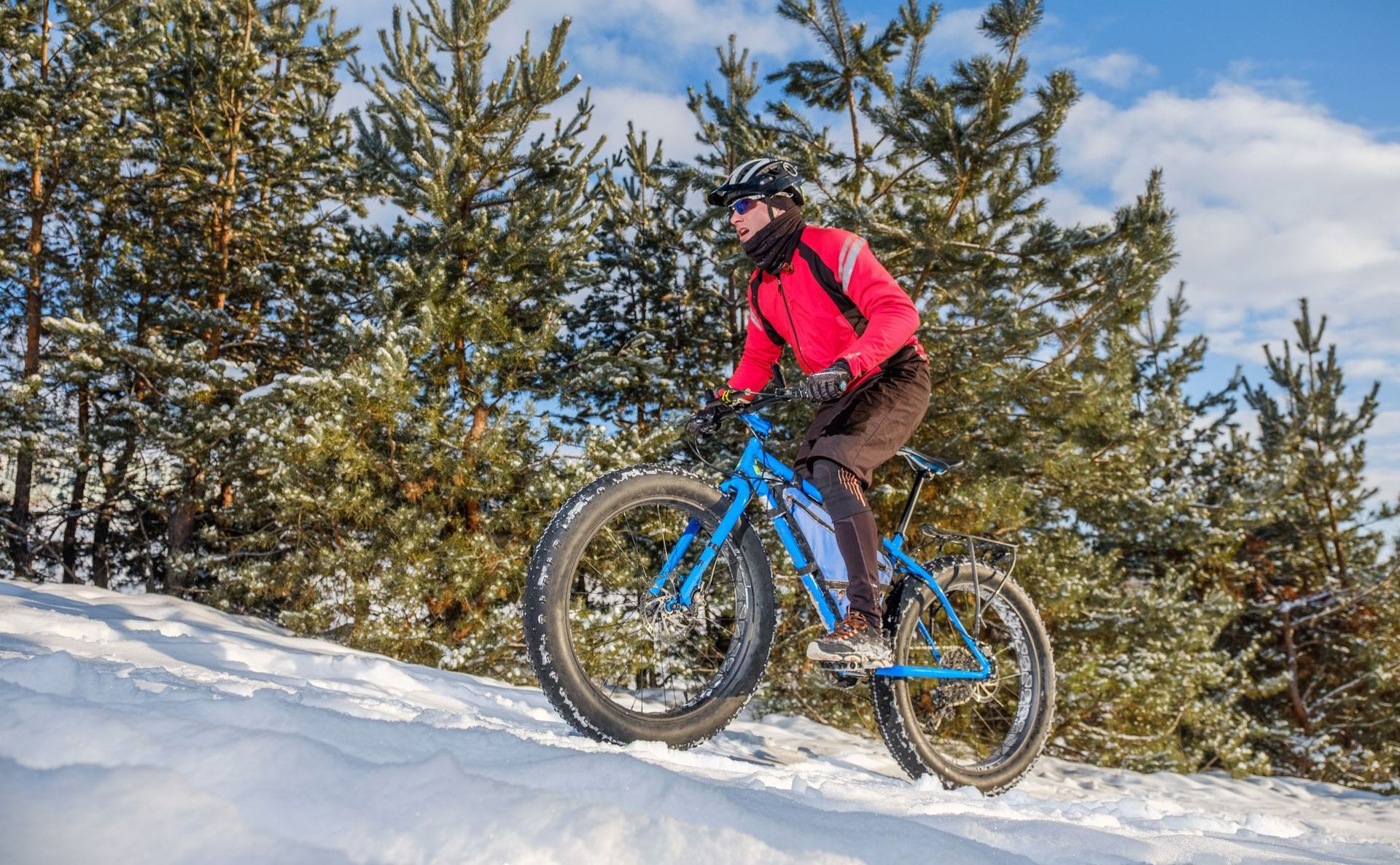 A person is riding a bike in the snow.