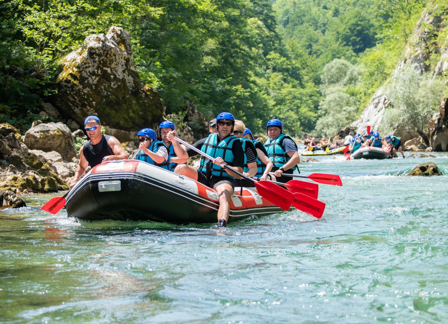 A group of people are rafting down a river.