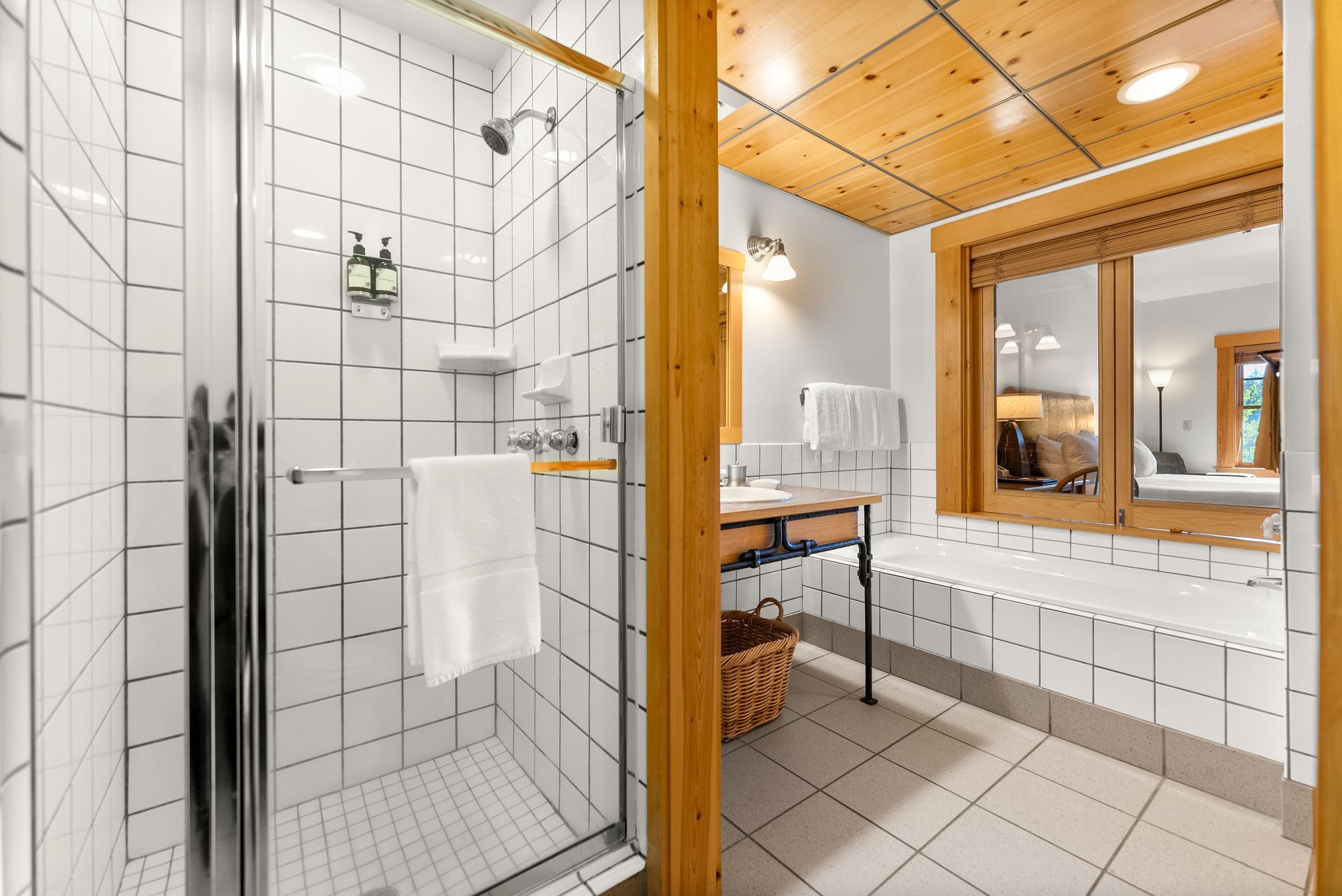 A bathroom with a walk in shower and a bathtub.