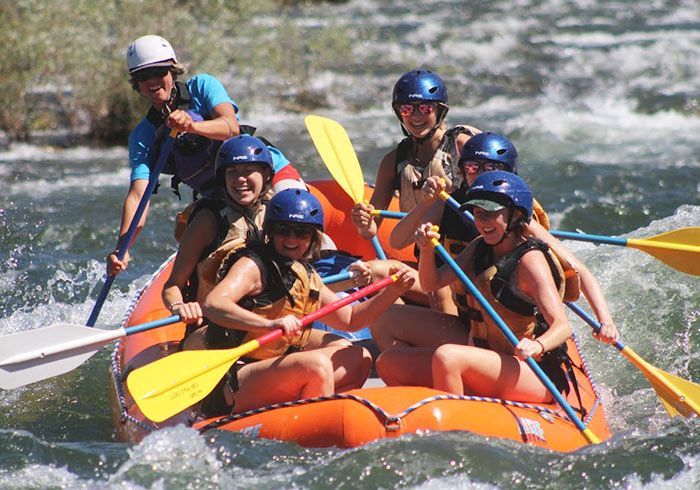 A group of people are rafting down a river