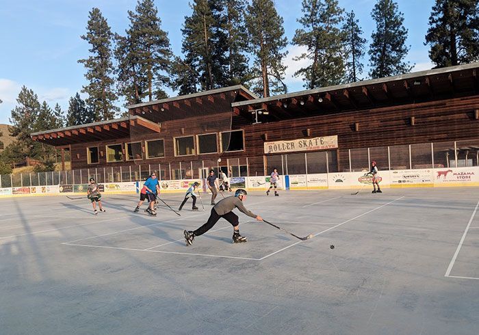 A group of people are playing ice hockey on a rink.