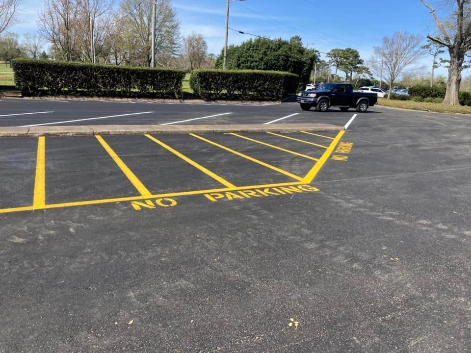 A paved parking lot with yellow-painted 