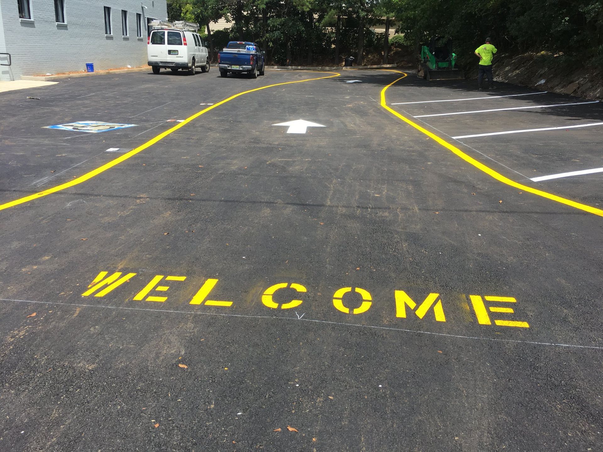 Newly paved parking lot with a yellow 