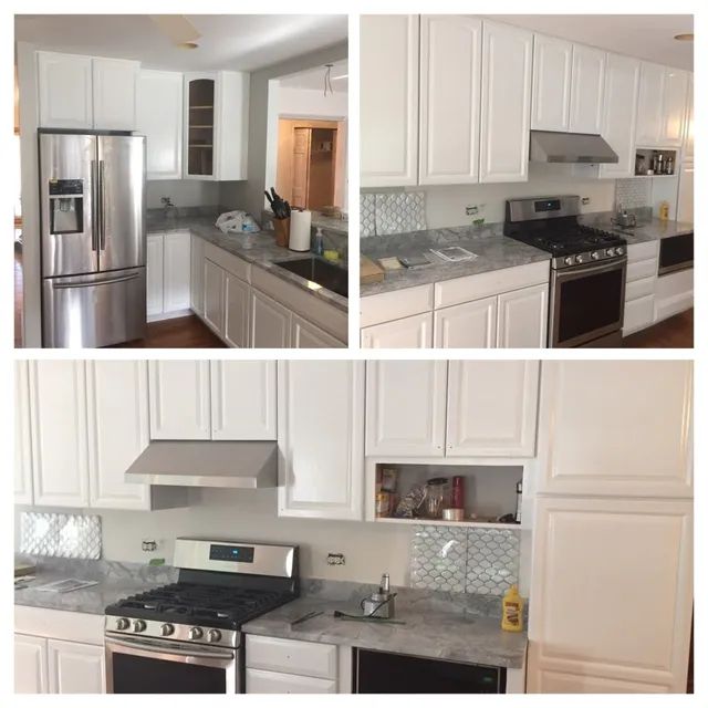 White kitchen cabinets with stainless steel appliances and gray countertops.